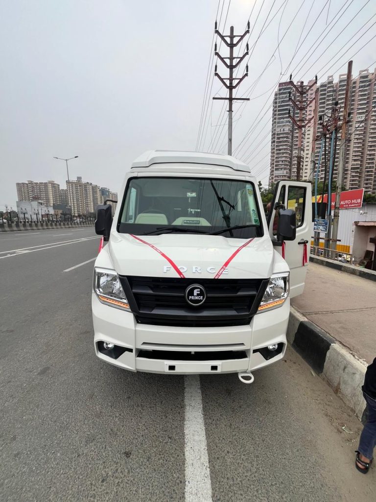 White Force Tempo Traveller front view with red ribbon